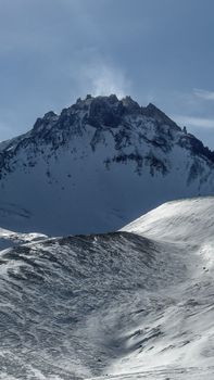 A breathtaking view of the snow-covered Erciyes Mountain under a clear sky, showcasing winter beauty.