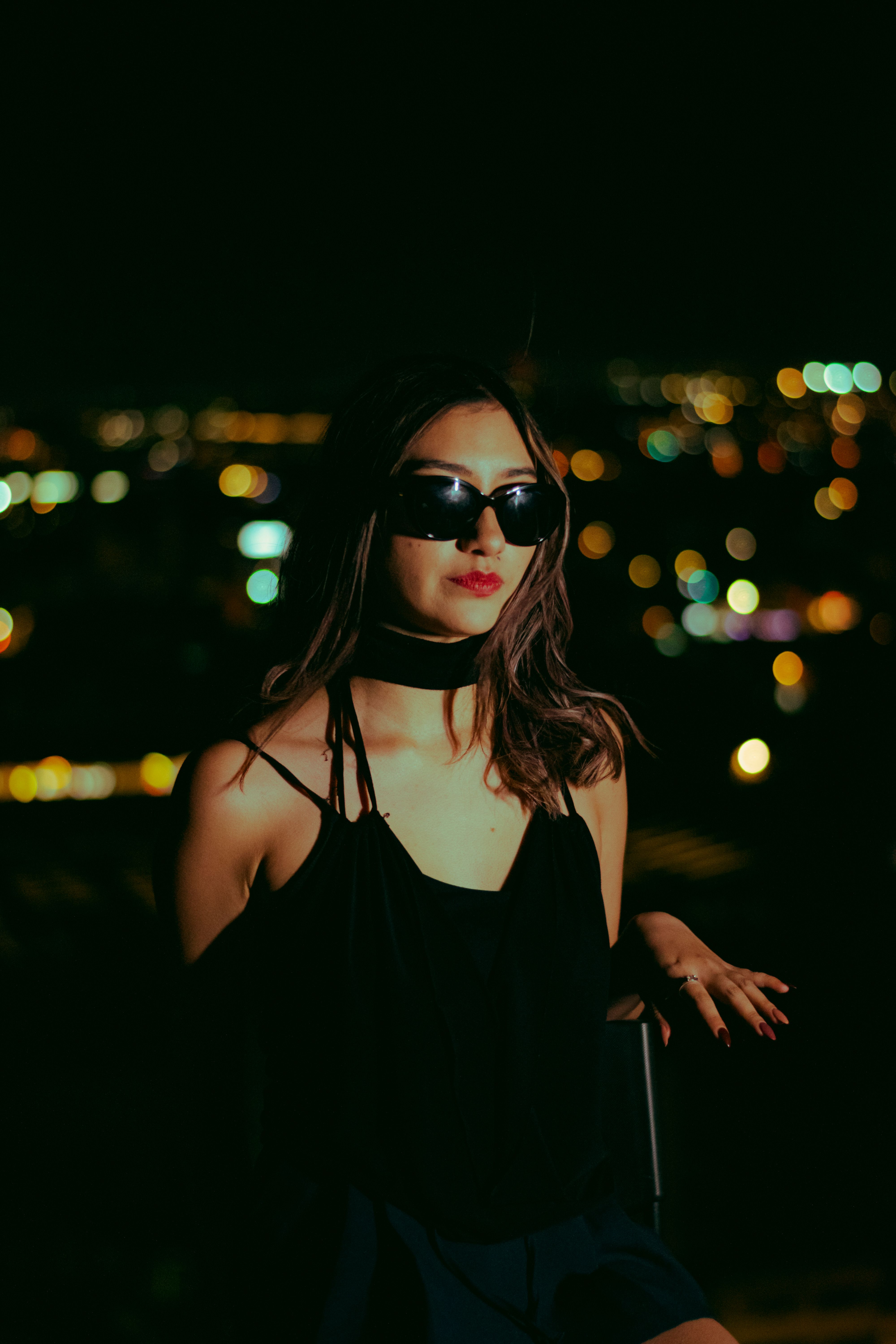Stylish Woman Posing at Night with City Lights · Free Stock Photo
