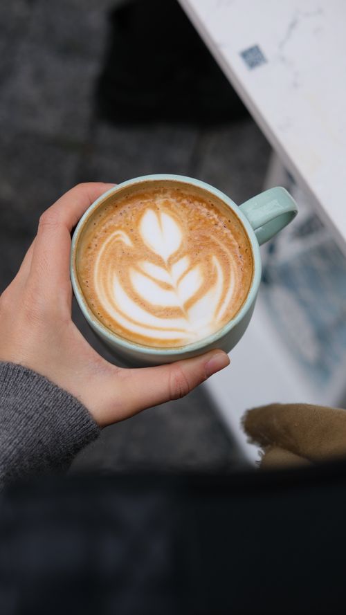 Free Enjoying a beautifully crafted latte art coffee outdoors in Istanbul, Turkey. Stock Photo