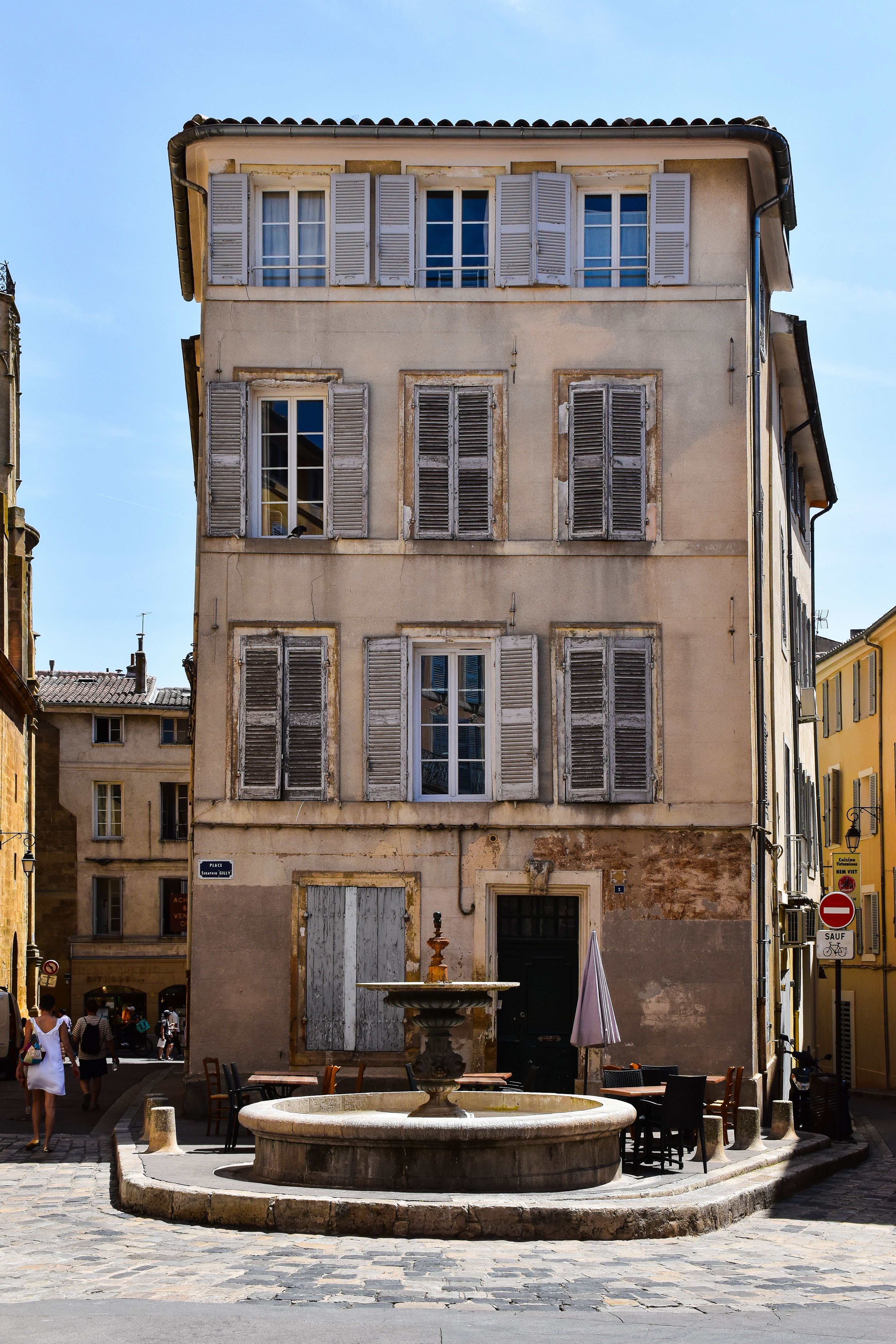 Captivating view of a historic building facade with shutters in Aix-en-Provence, France.