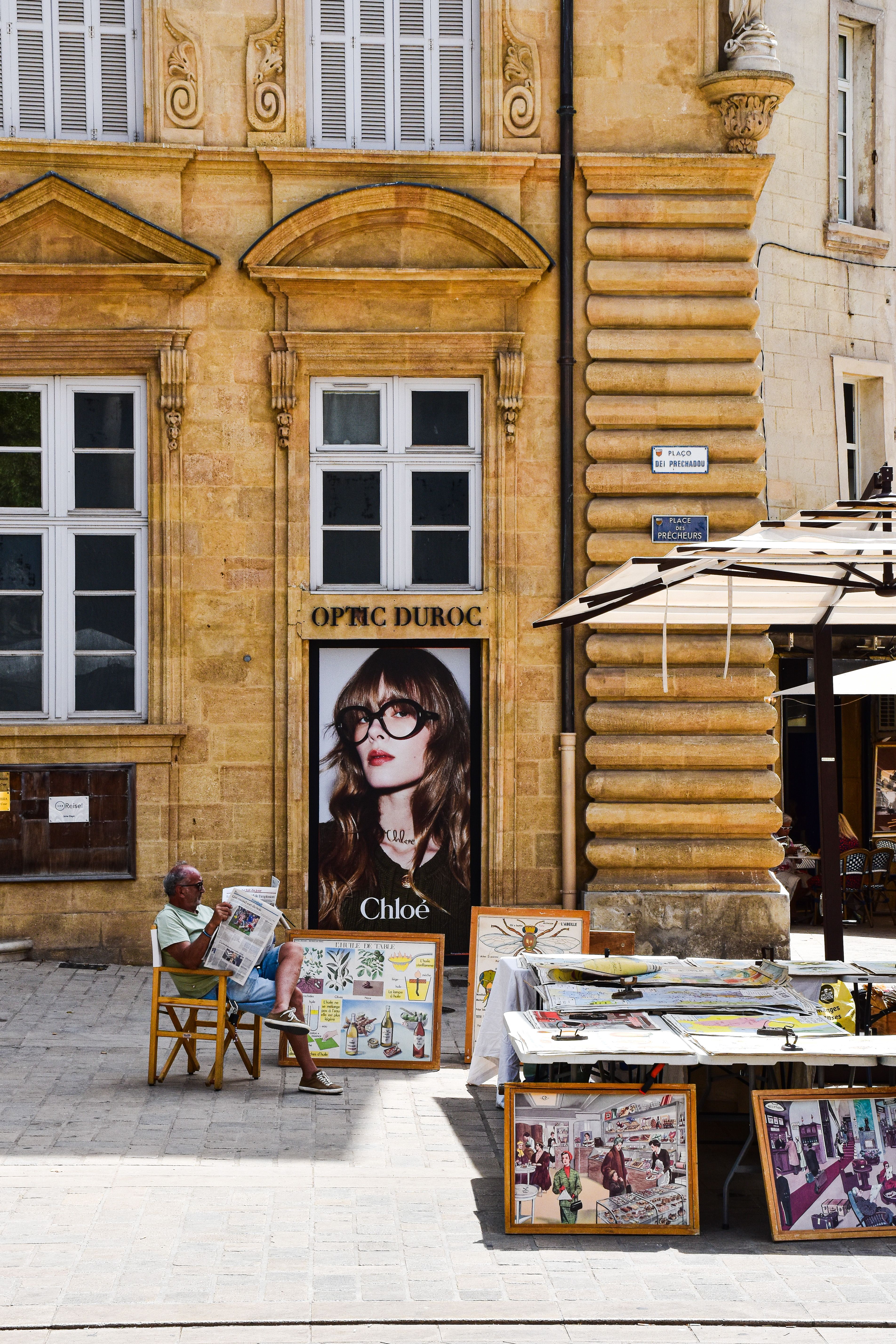 street scene in aix en provence with art vendor