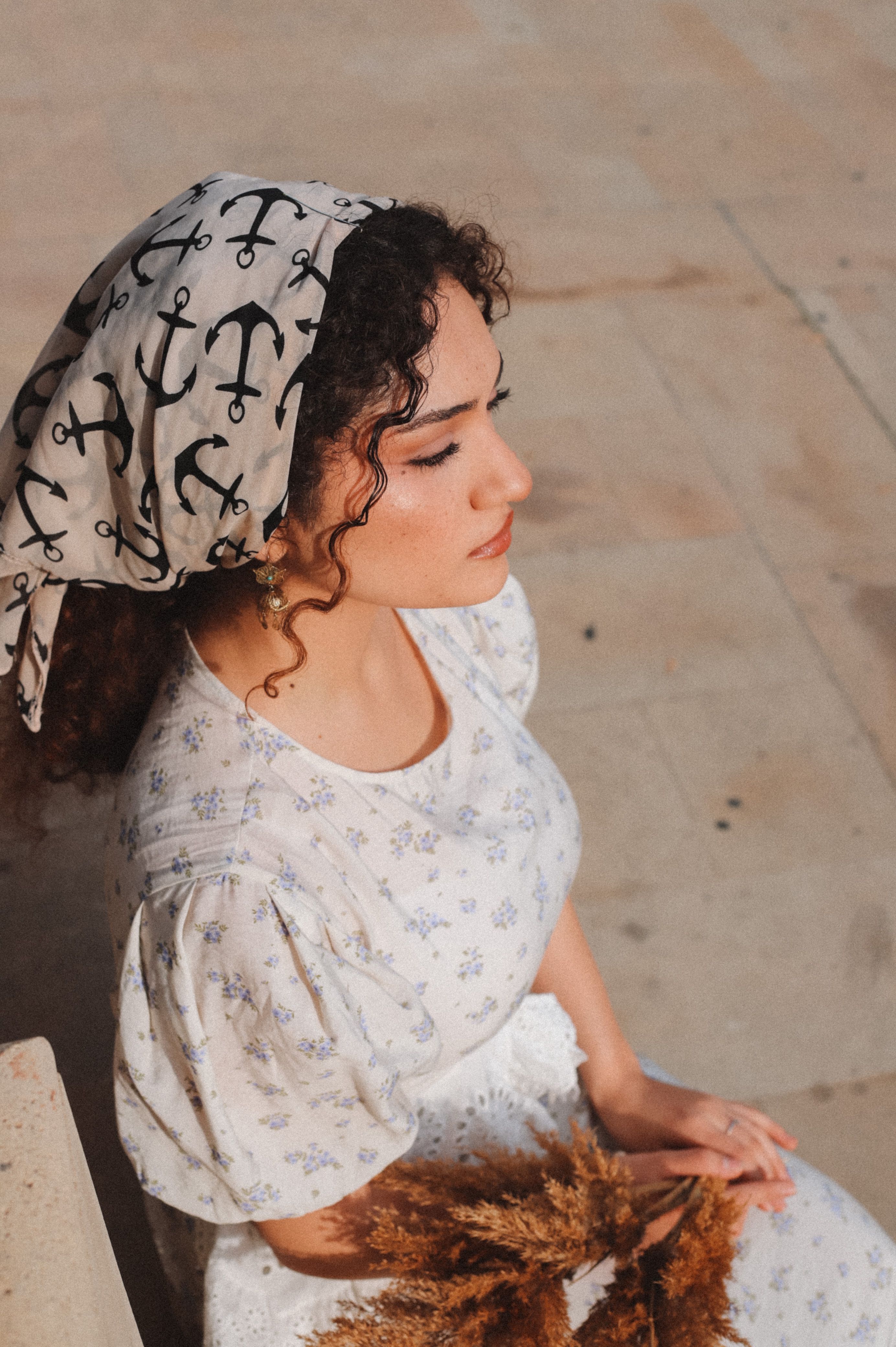 Elegant Woman in Floral Dress with Anchor Headscarf · Free Stock Photo
