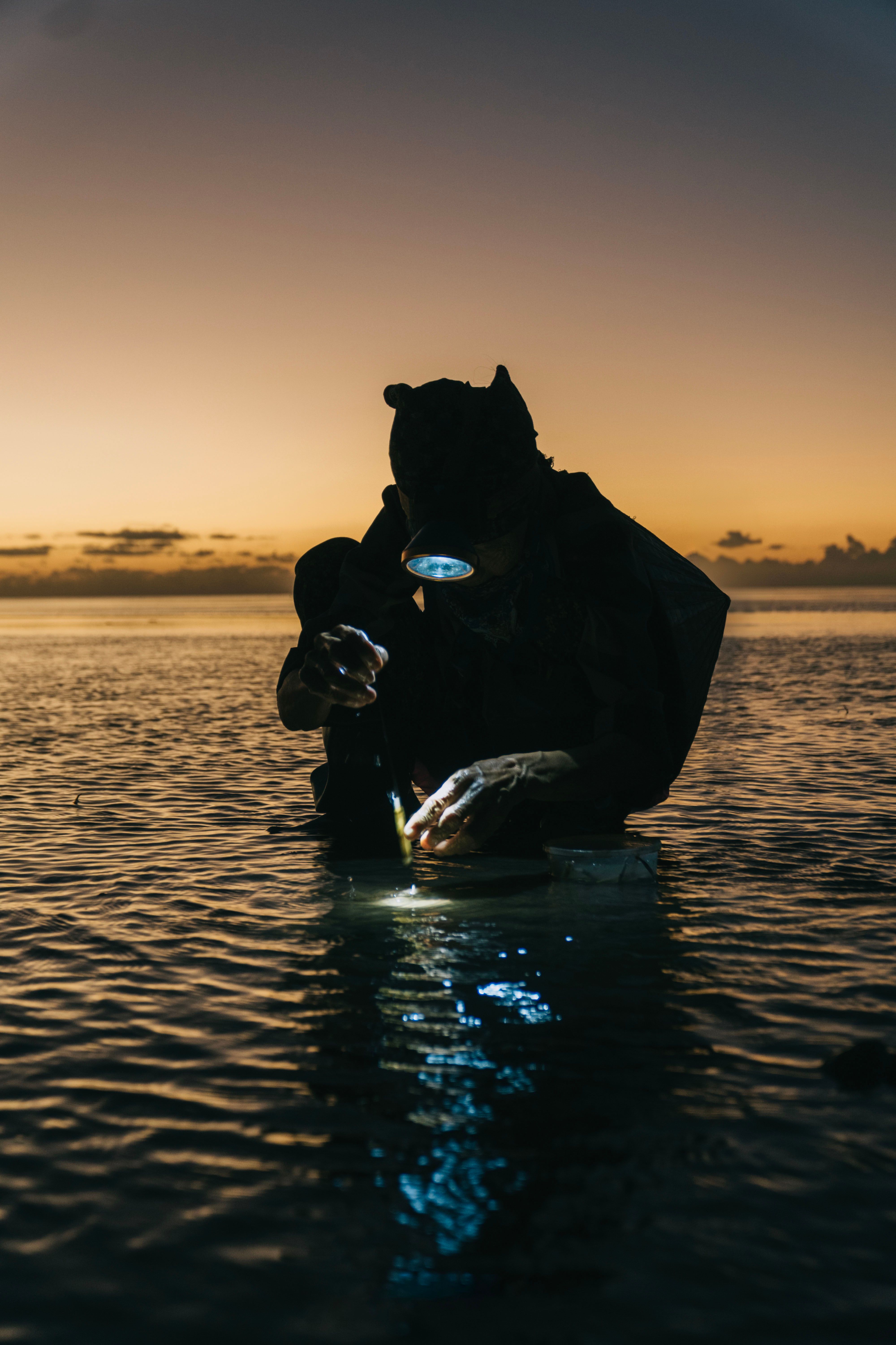 Silhouette of Fisherman at Sunset on Ocean · Free Stock Photo