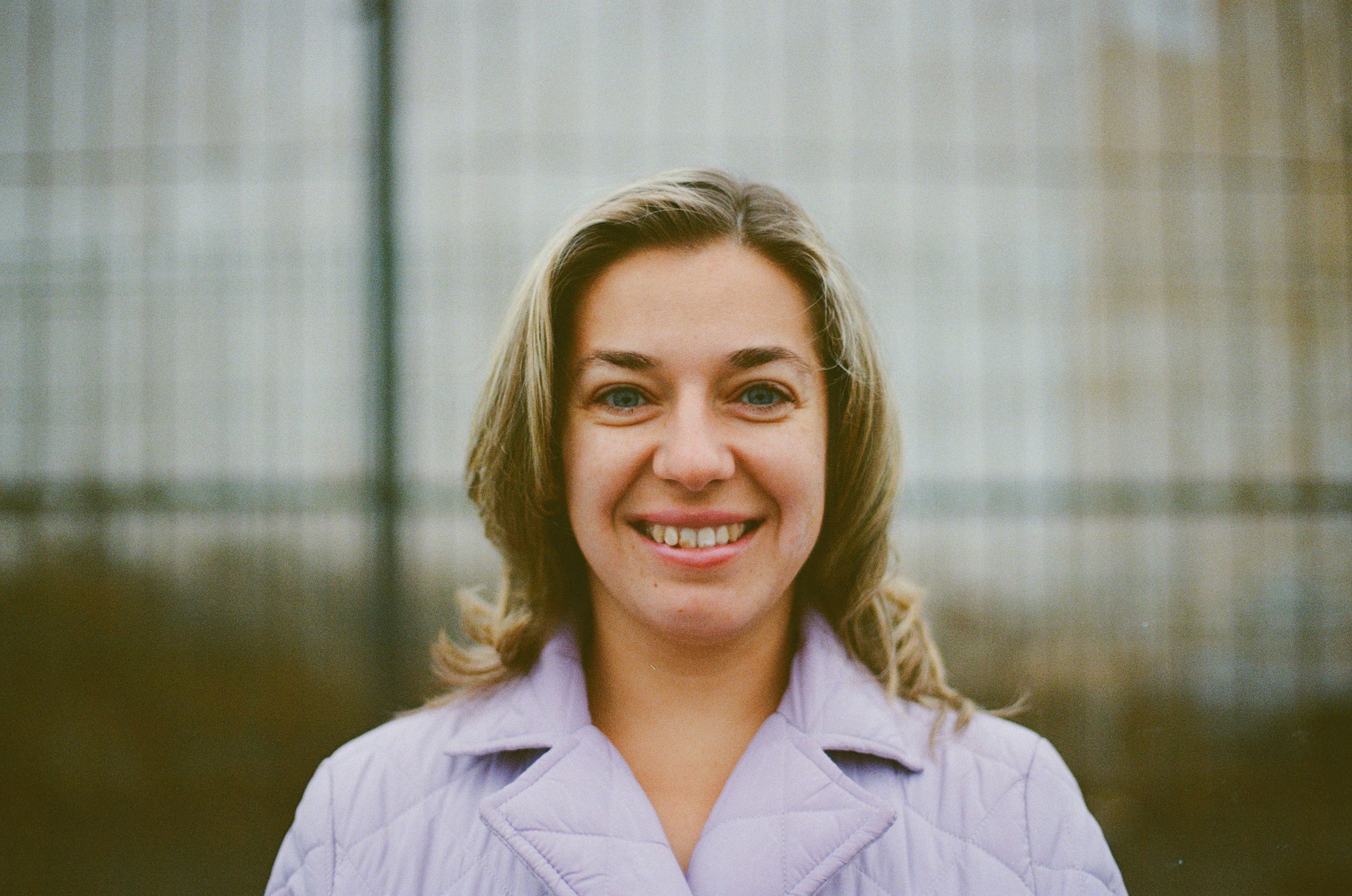 smiling woman feeling confident post-recovery - breast augmentation recovery tips