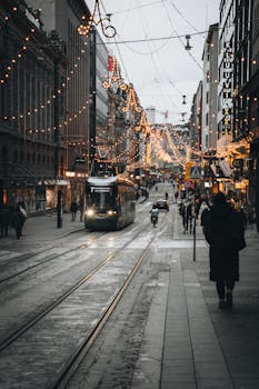 Winter scene in Helsinki's street with festive lights and tram. City life in Finland.