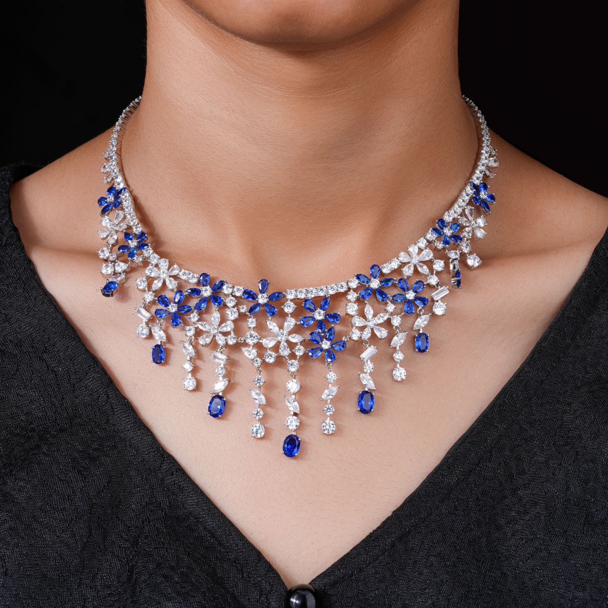 Model wearing a sapphire and diamond necklace