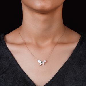 Butterfly pendant on a fine rose-gold chain, photo by The Glorious Studio on Pexels