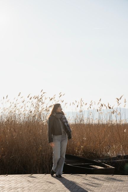 A woman enjoying the calm and scenic view of the lake and reeds at Ohrid, North Macedonia.