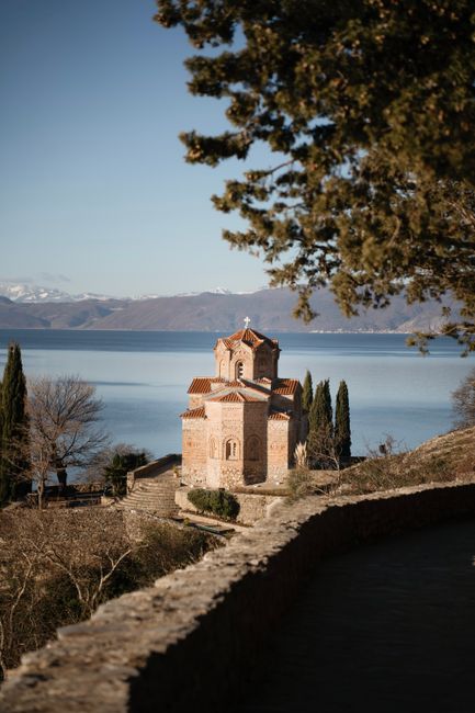 Charming view of Saint John at Kaneo church by Lake Ohrid in Macedonia, captured in vivid daylight.