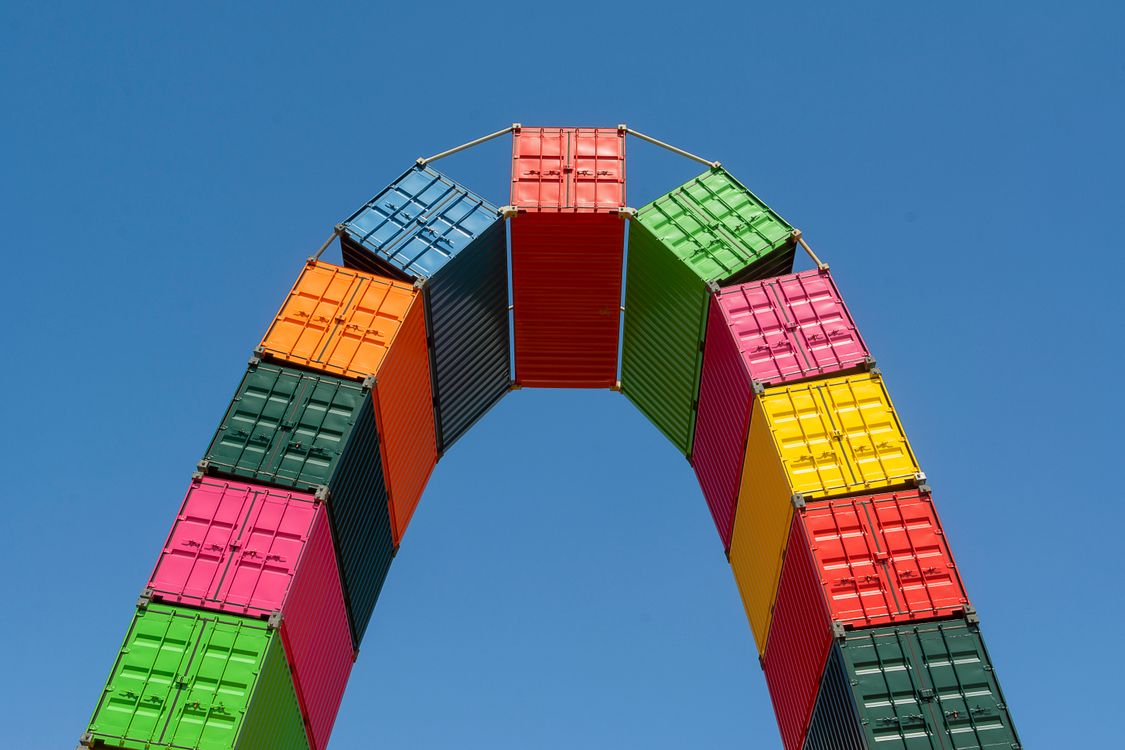 Container Archway Colorful Shipping Container Arch against Blue Sky · Free Stock Photo
