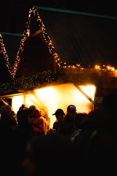 Crowded Hamburg Christmas market with illuminated stalls and winter night ambiance.