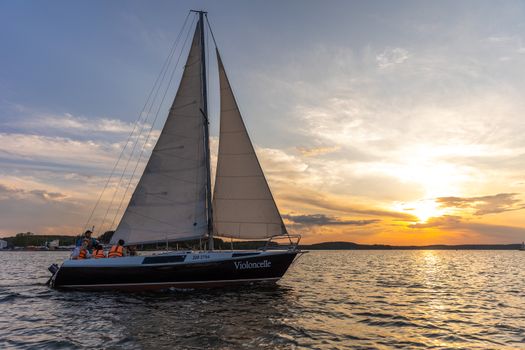 A group enjoys a scenic sunset sail on calm waters, capturing the essence of relaxation and travel.