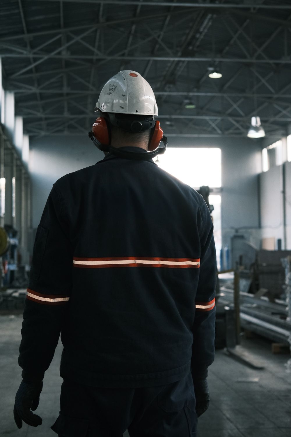 Worker in protective gear overseeing production