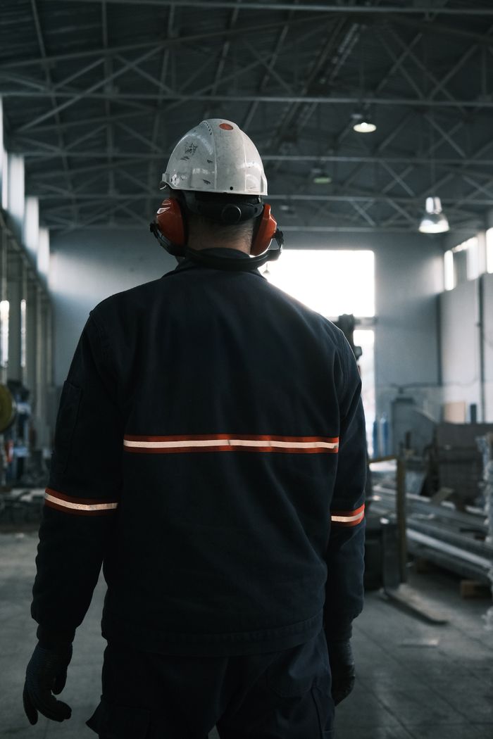 Worker in safety gear inside a hygienic production facility