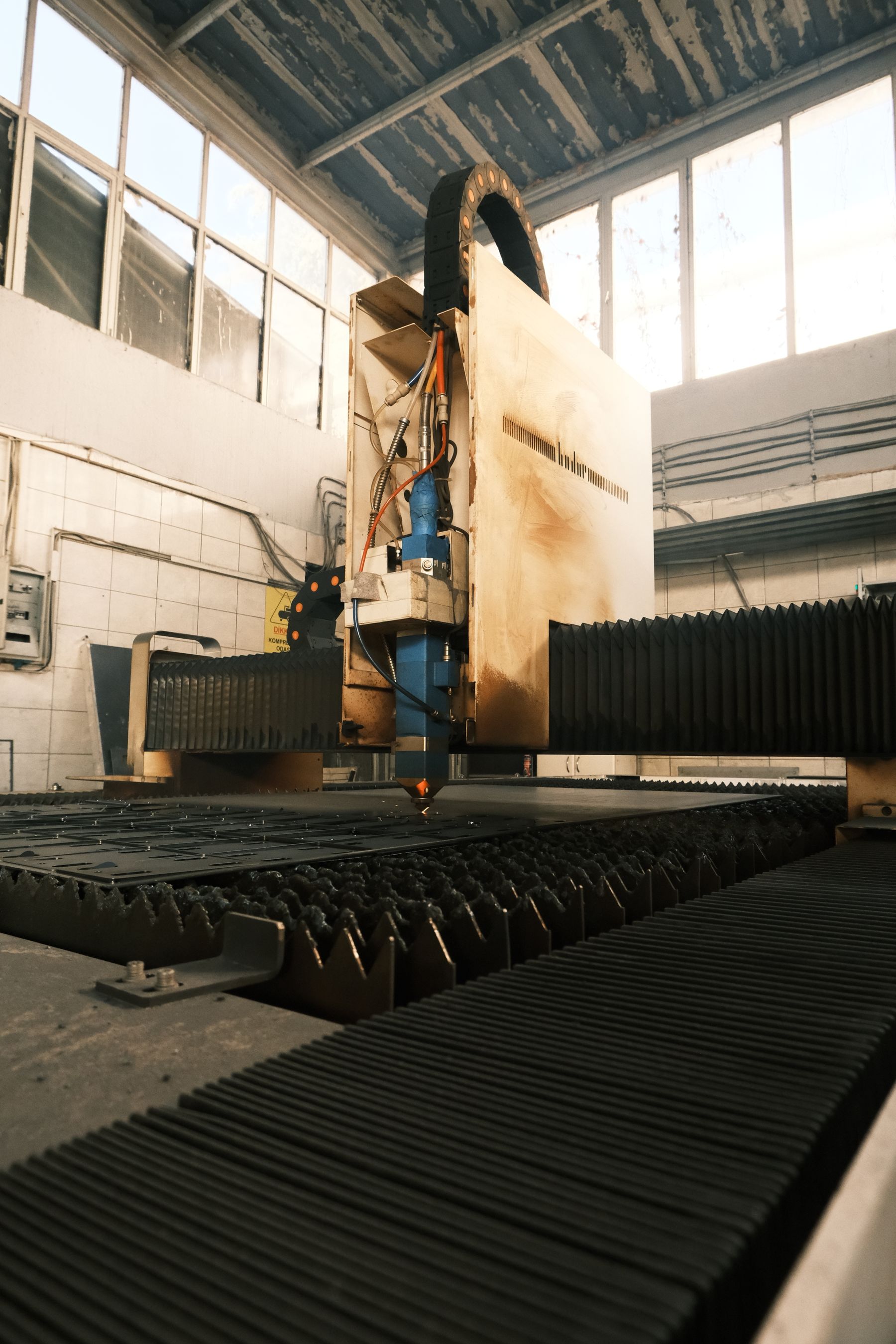 Industrial fiber laser machine working over a long bed in the workshop