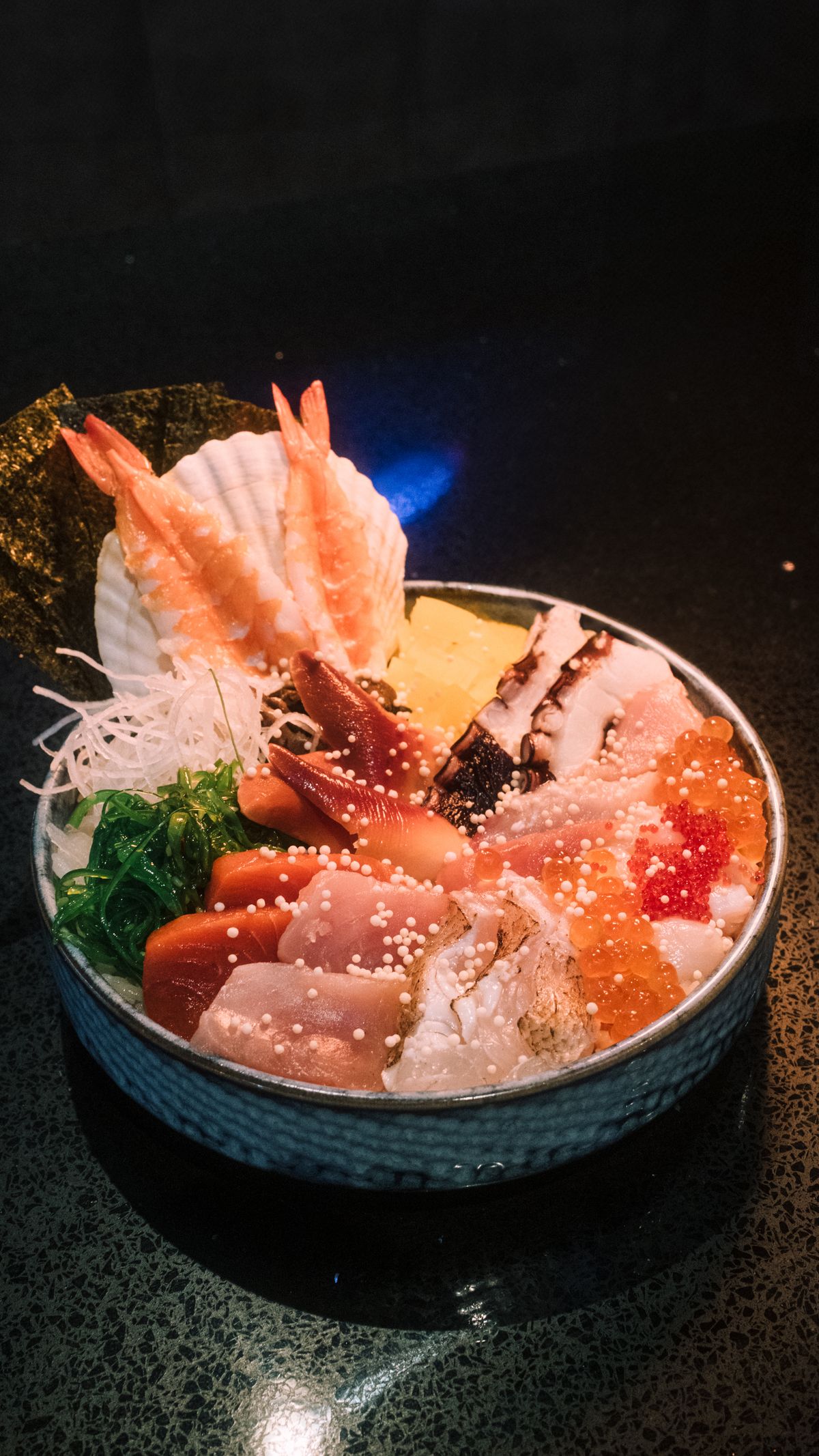 Fresh seafood chirashi rice bowl with sushi and garnishes, like a Hakodate kaisendon