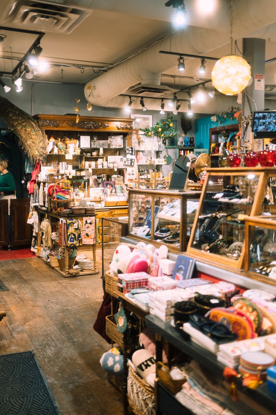 Interior of an eclectic boutique with shelves crowded with gifts, prints and curiosities