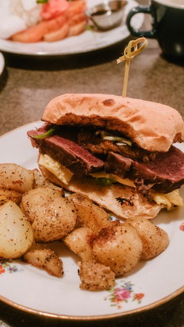 A roast beef sandwich on a tray, illustrating an Arby's price comparison.