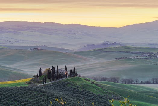 Captivating view of Tuscany's rolling hills and cypress trees at sunrise.