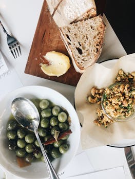 Artisan bread and green olives served with gourmet appetizers. Perfect for food enthusiasts.