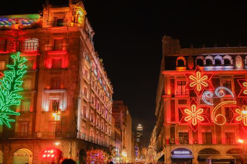 Free Vibrant Christmas decorations illuminate historic buildings in Mexico City at night. Stock Photo