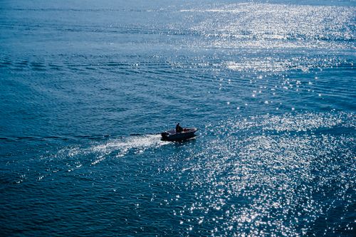 People Riding a Boat on a Body of Water · Free Stock Photo