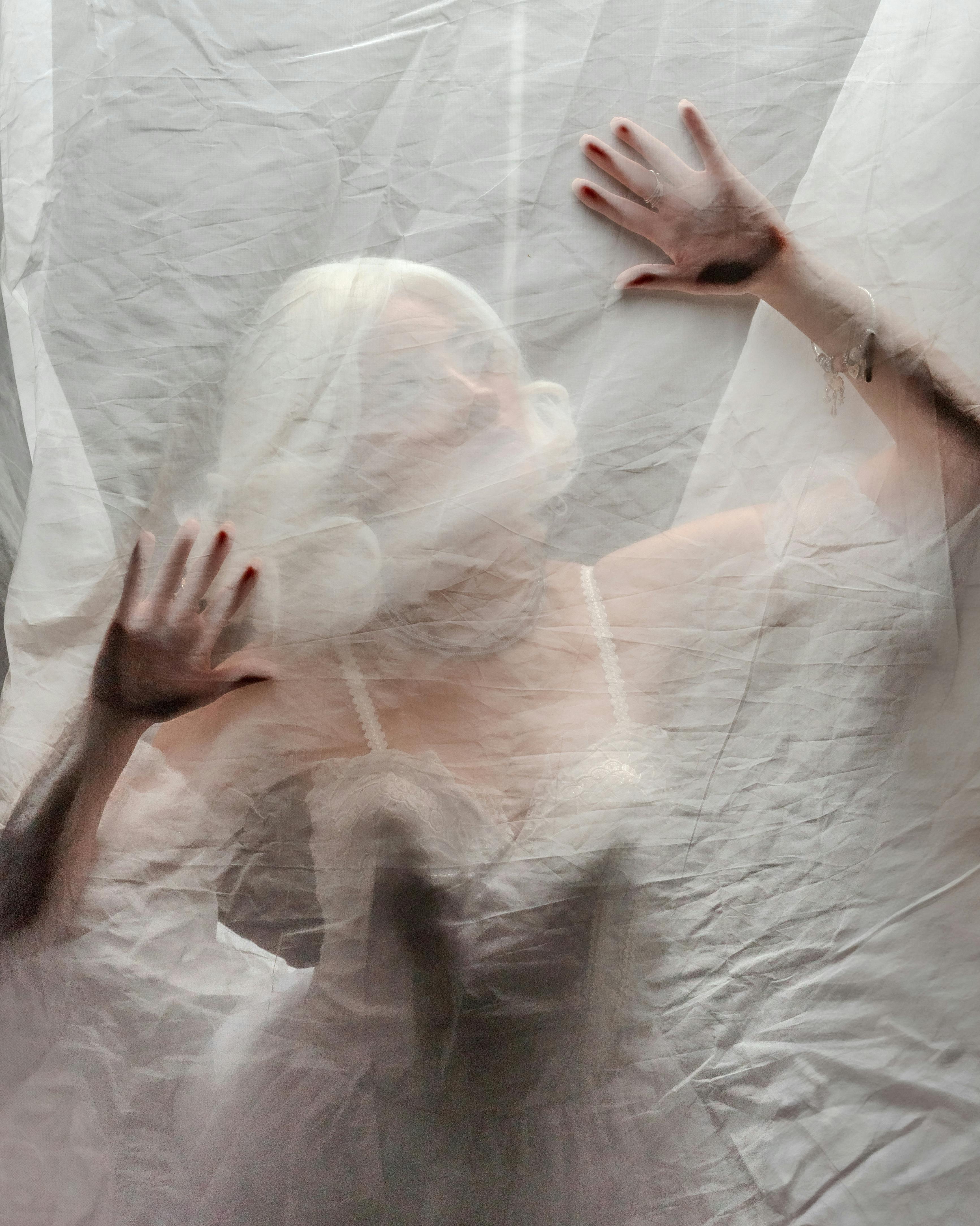 A mysterious and artistic portrait of a woman behind a sheer veil, embodying elegance and empowerment.