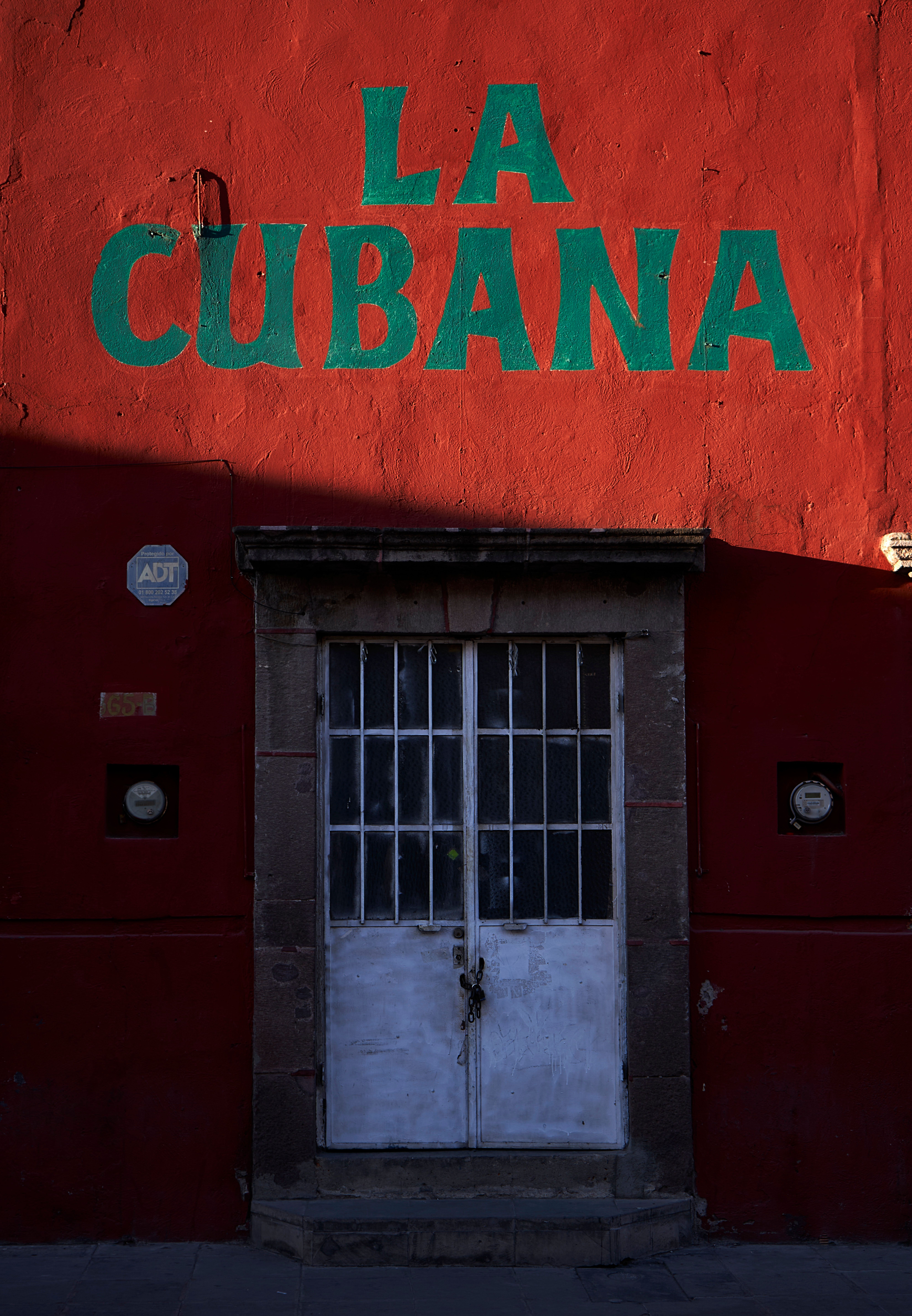 A colorful facade of a building in San Luis Potosí featuring a prominent 'La Cubana' sign above a rustic door.