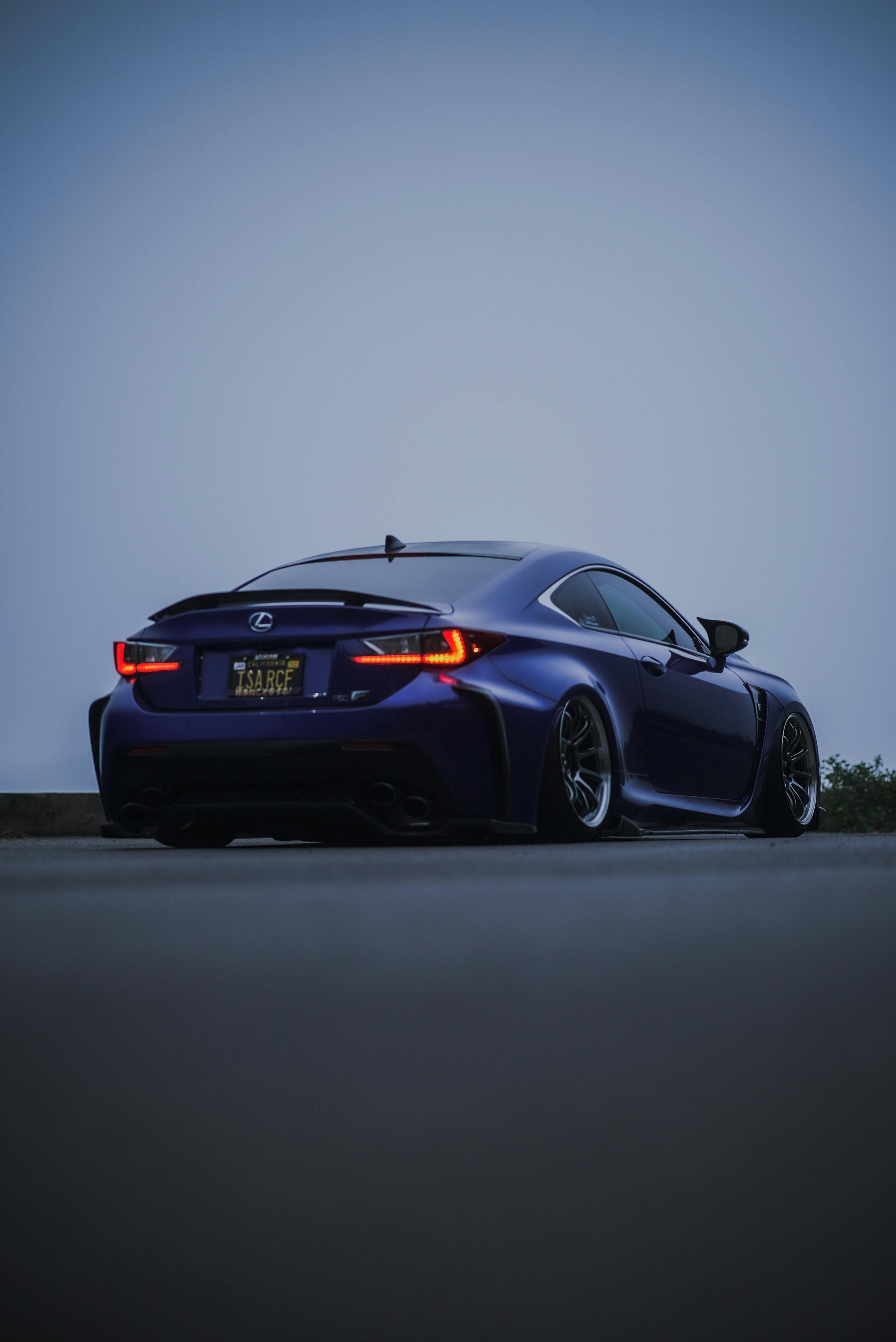 Free Sleek luxury sports car photographed at twilight offering a moody atmosphere. Stock Photo