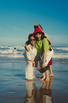 Happy group of friends laughing and bonding at sunset on Phan Thiet beach, Vietnam.