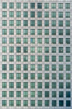 Detailed view of a modern office building in London with a striking grid pattern of windows.