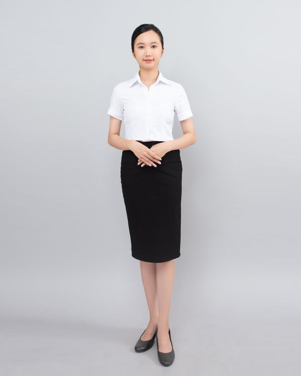 Woman in an A-line midi skirt with a cardigan
