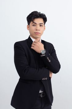A confident adult man posing with folded arms in a black suit against a white background.