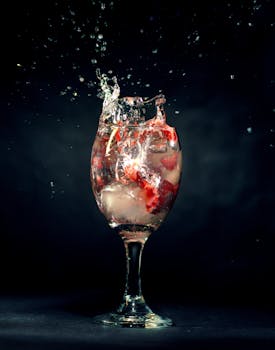 A vibrant splash captures a cocktail moment in a studio setting.