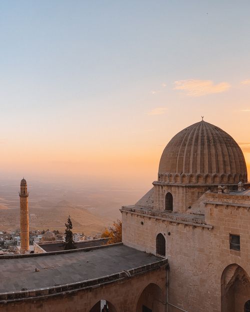 Free Beautiful sunset over Mardin's ancient architecture with domed roofs and a distant minaret. Stock Photo