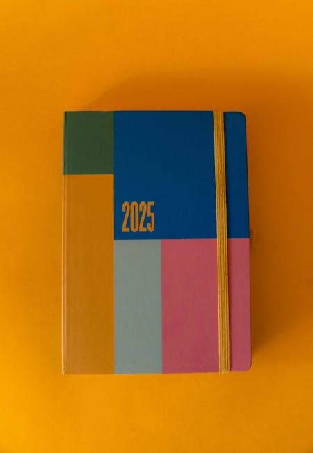 Bright 2025 planner on a bold yellow background, perfect for organizing the year ahead.