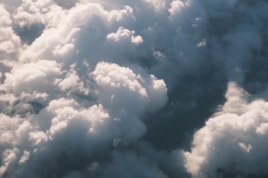 Breathtaking aerial shot of clouds with soft sunlight at sunrise.