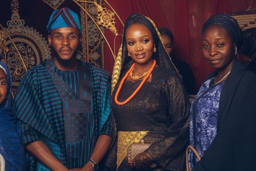 Free Group of adults in traditional Nigerian attire at a ceremonial event, showcasing cultural fashion. Stock Photo
