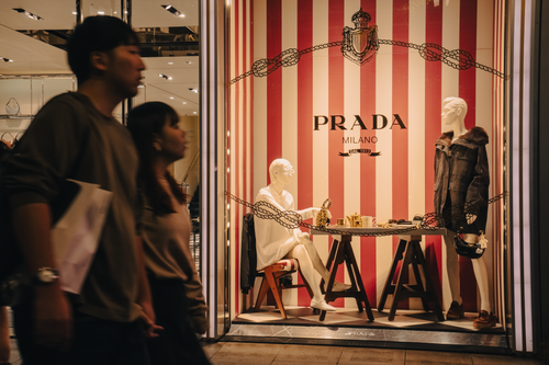 Free Mannequins in Prada store window with pedestrians passing by in Osaka. Stock Photo
