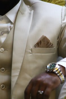 Close-up of a stylish beige suit with a pocket square. Ideal for formal attire and fashion concepts.