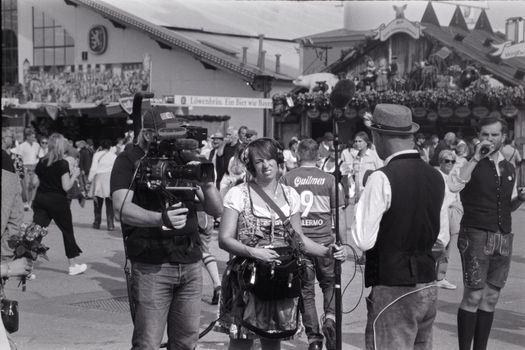 Black and white photo of Oktoberfest capturing people in traditional Bavarian attire.