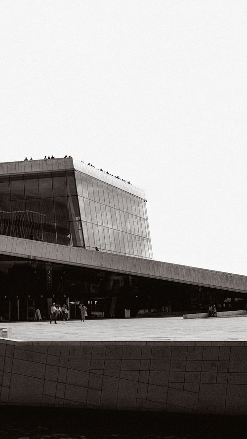 Free A striking black and white photo of the Oslo Opera House showcasing its modern architectural design. Stock Photo