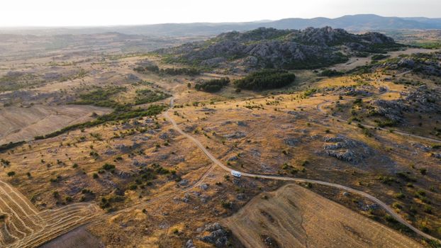 Drone shot of a rocky terrain and road in Türkiye, under daylight.