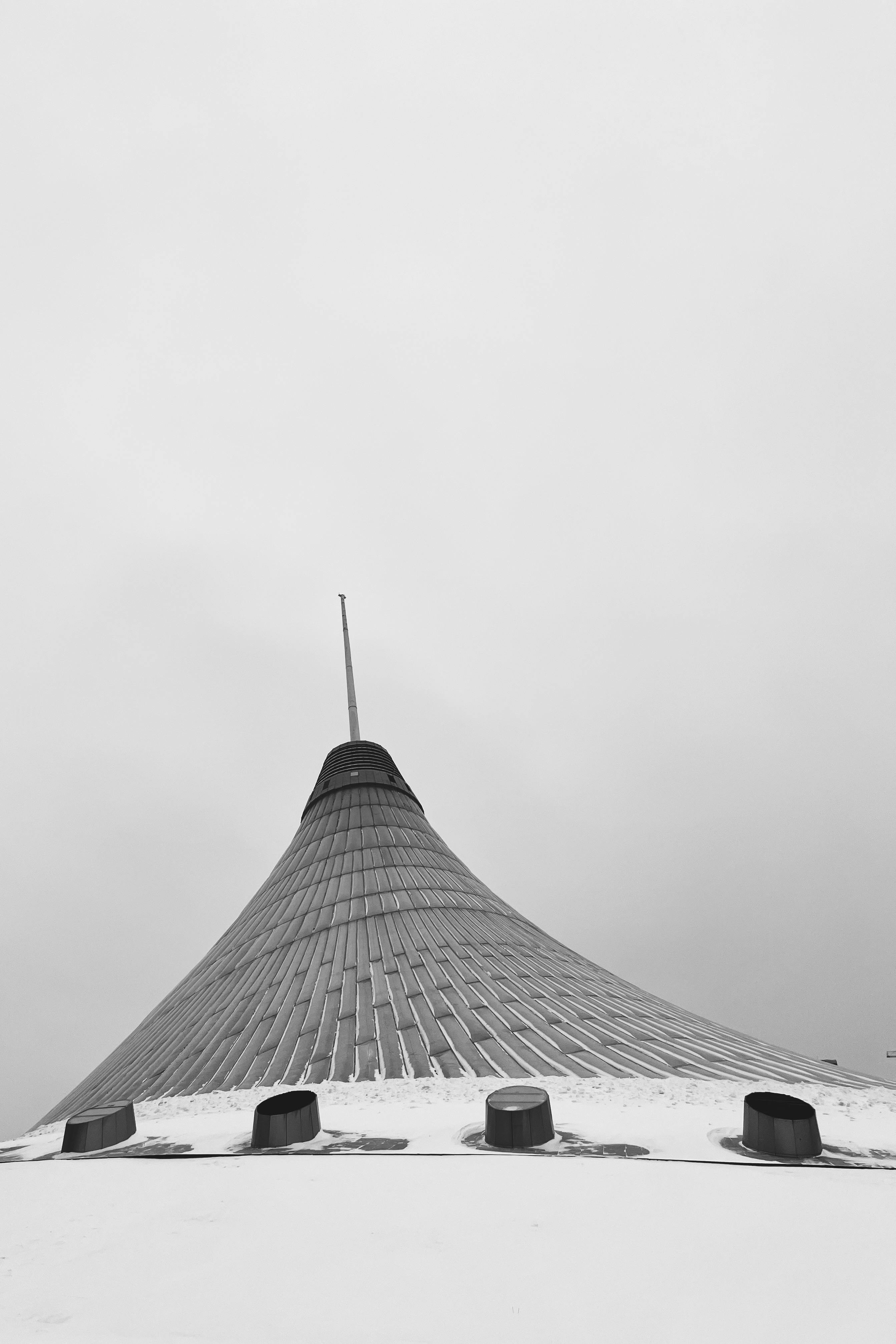 Black and white view of Khan Shatyr against a snowy sky in Astana, Kazakhstan.