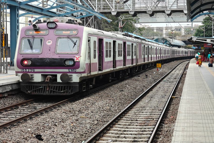 A suburban commuter train stationed at a platform in Hyderabad, India, showcasing urban transport.