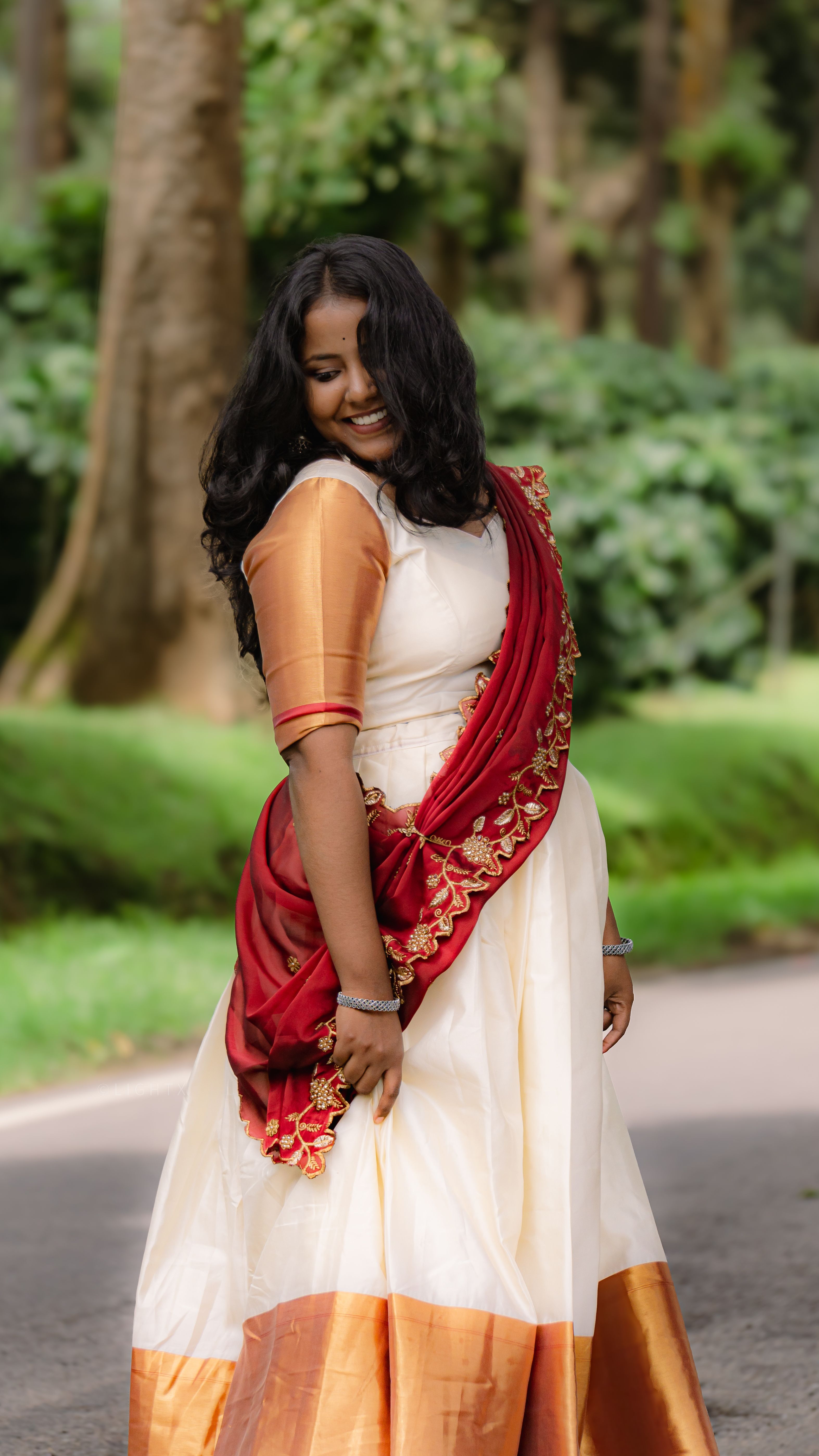 Young woman in traditional Indian sari enjoying nature outdoors.