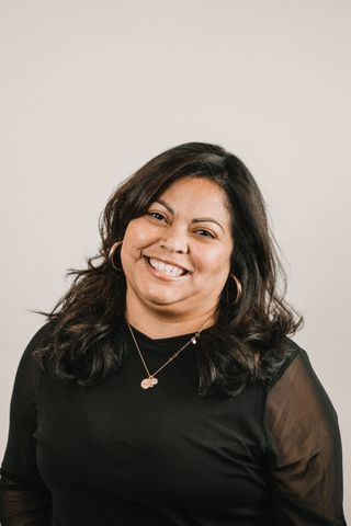 Professional woman smiling in a studio portrait