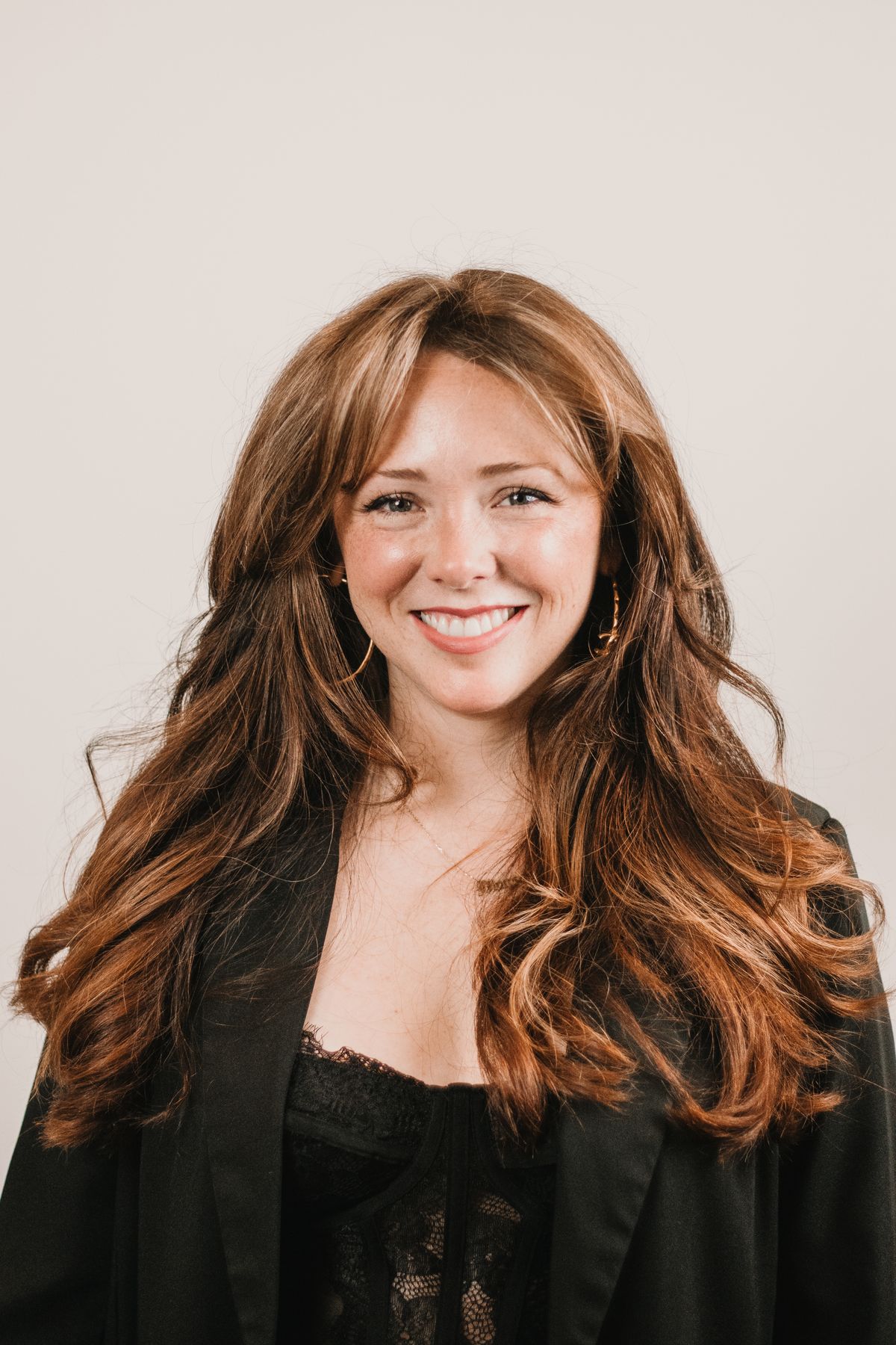 Professional headshot of a smiling woman in business attire