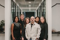 Diverse team of professionals posing in a modern office hallway in Greenville, SC.