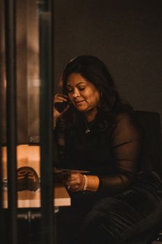 A professional engaged in a phone call at a Greenville office, displaying confidence and elegance.